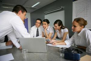 A team of employees discusses ideas at a meeting.